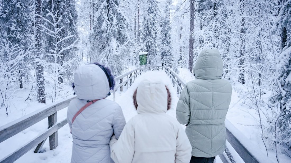 Guests photographing on a snowy path