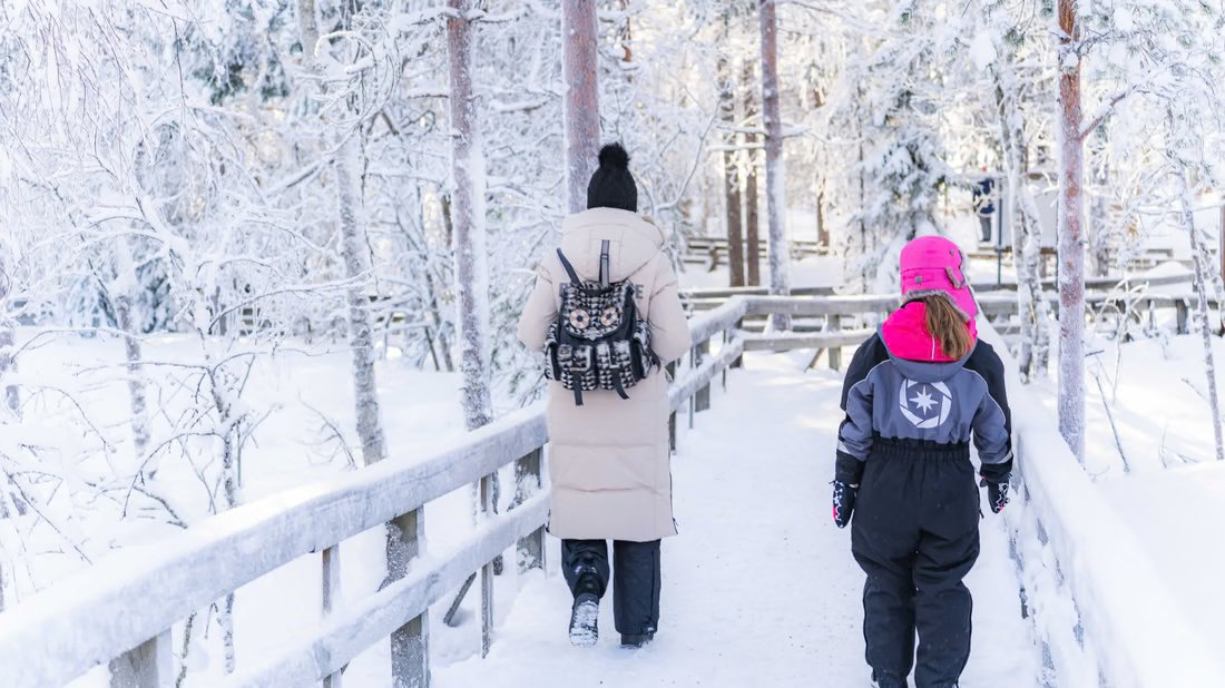 Guests walking on a snowy boardwalk