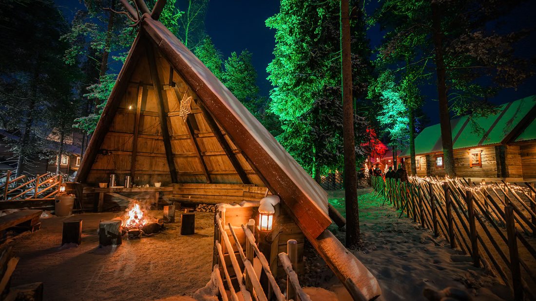 Lappish fire shelter lit up in the evening